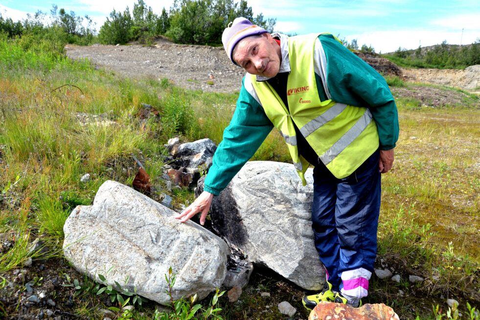 Her viser Paul Undheim med hånden hvor på steinen korset han ser, er, og fuglen vi mener å se hugget inn er på den siden som vender mot veien og innkjørselen til grustaket på Hamnbuktbakken litt utenfor Lakselv.
 Foto: Sonja E Andersen