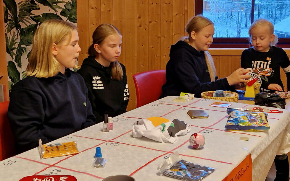 Tombolabordet var populært blant barna. Her er Henry spent på om Arja ruller frem en kule med gevinst. Kari og Madelene hjelper med å sjekke om han vant.
 Foto: Hill Haga