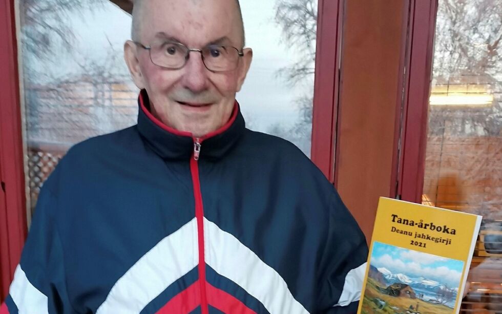 Bilderedaktør Olav E. Johansen med Tana-årboka 2021. Forsidebildet er et maleri av Ivar Sælø fra 1950 som viser utsikt over det som i dag kalles Tanamunningen naturreservat.
 Foto: Privat