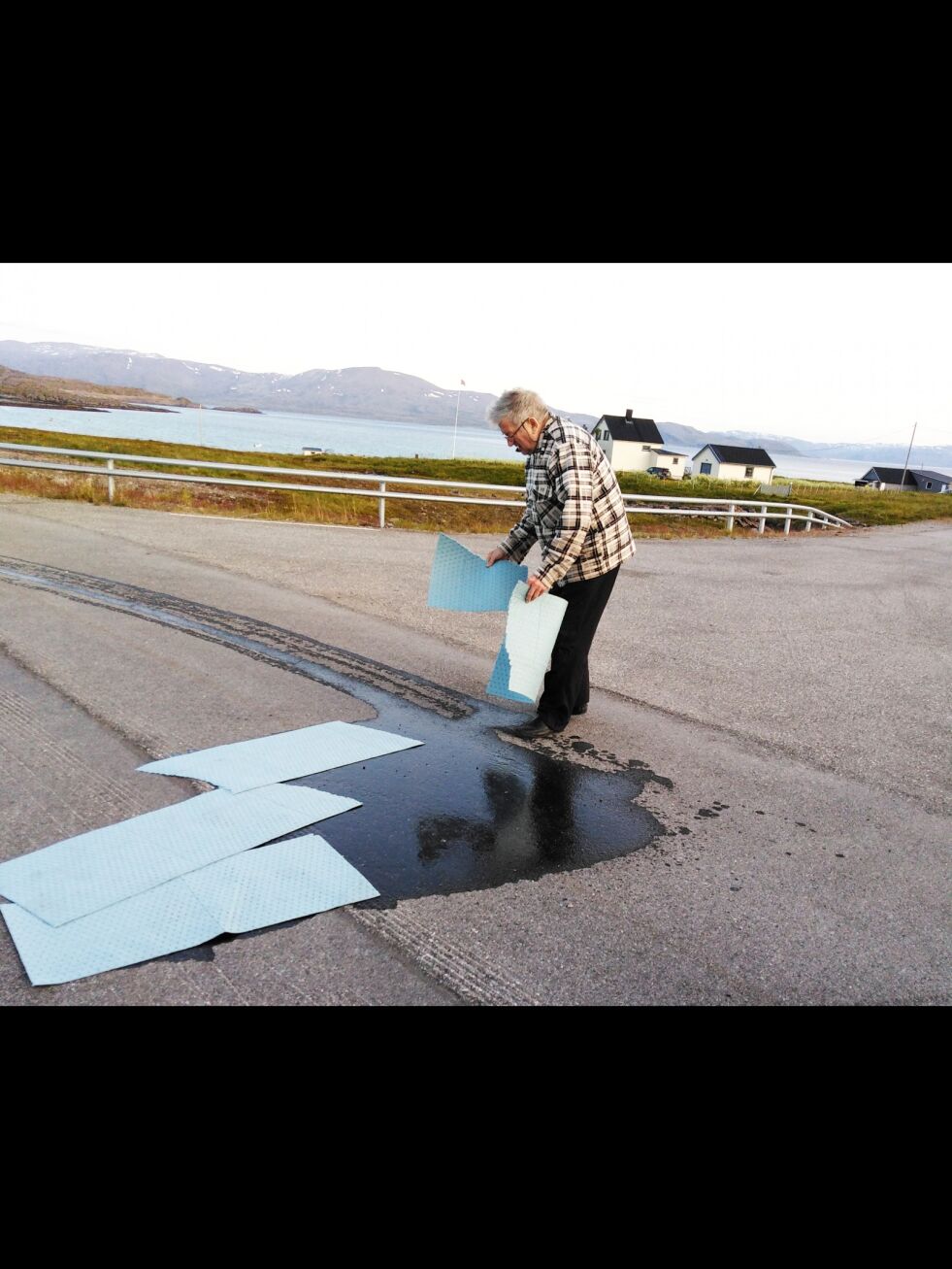 Sist torsdag kveld måtte Bernt Skogen som medeier i Finnmark Turbuss, ut for å fjerne oljesøl på den nasjonale turistveien til Havøysund etter et busshavari i Lillefjord i Måsøy.
 Foto: Privat
